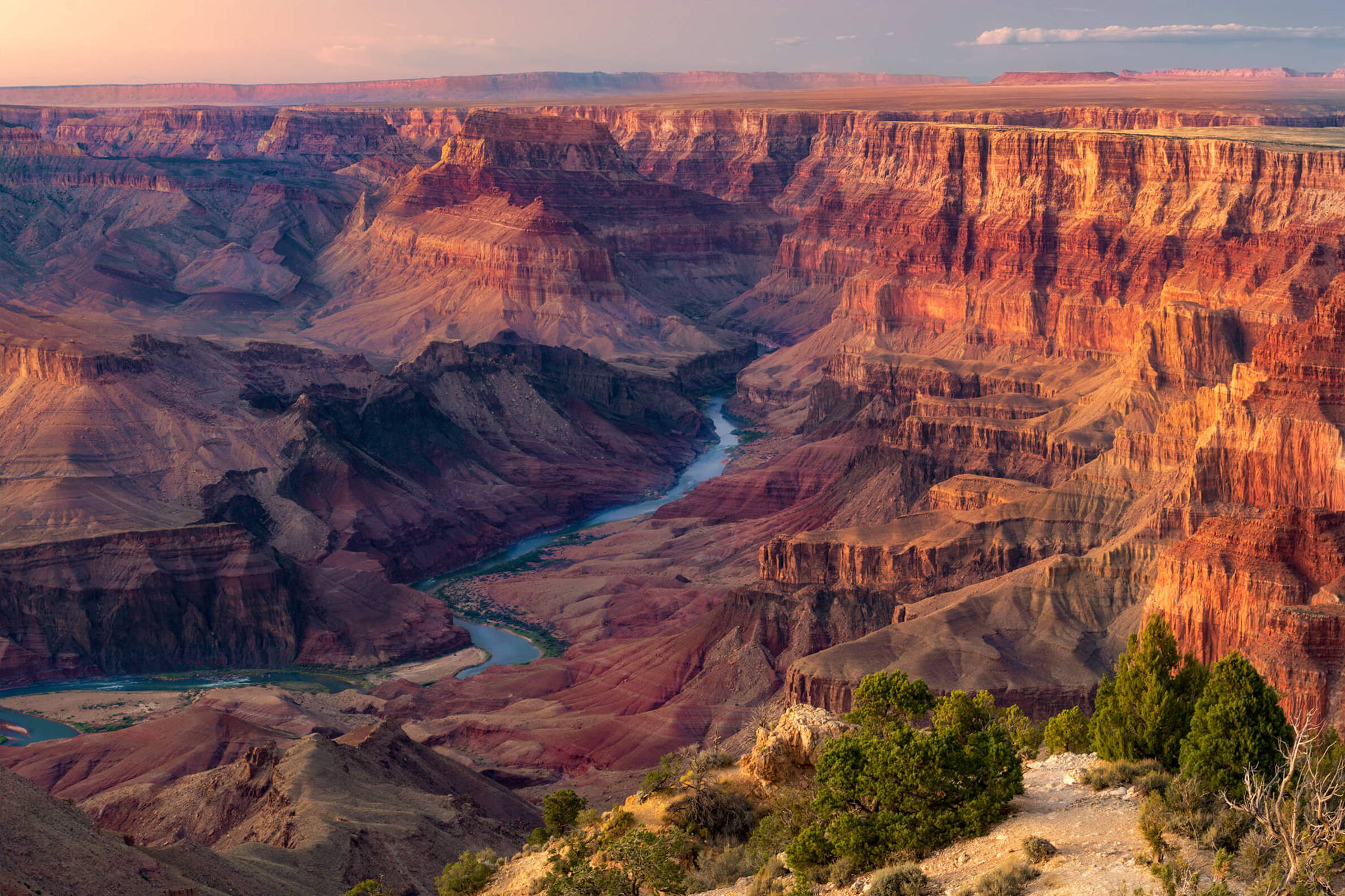 The Colorado River winding through the Grand Canyon at sunset