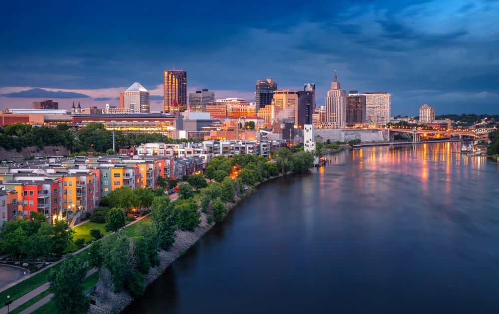 A scenic evening view of the St. Paul, Minnesota skyline reflecting on the calm waters of the Mississippi River.